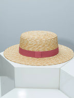 Elegant straw boater hat with decorative ribbon from Plush Fashion Hub, perfect for summer fashion and sun protection.