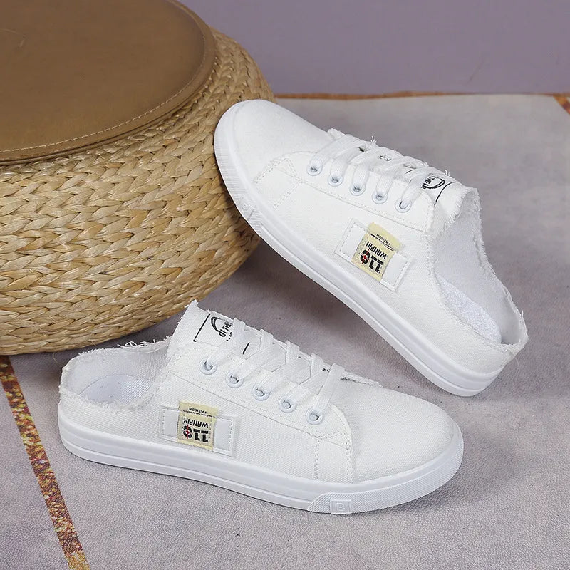 Frayed hem lace-up canvas sneakers in white with distressed details and casual style, designed by Trendsi.