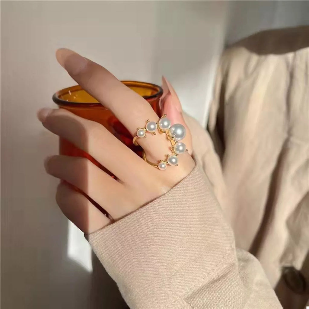 Silver alloy pearl open ring with a sleek design, featuring a prominent pearl accent on a stylish open band.