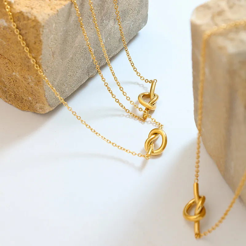 18K gold-plated titanium steel knot necklace with a sleek, polished finish, showcasing its elegant and modern design.