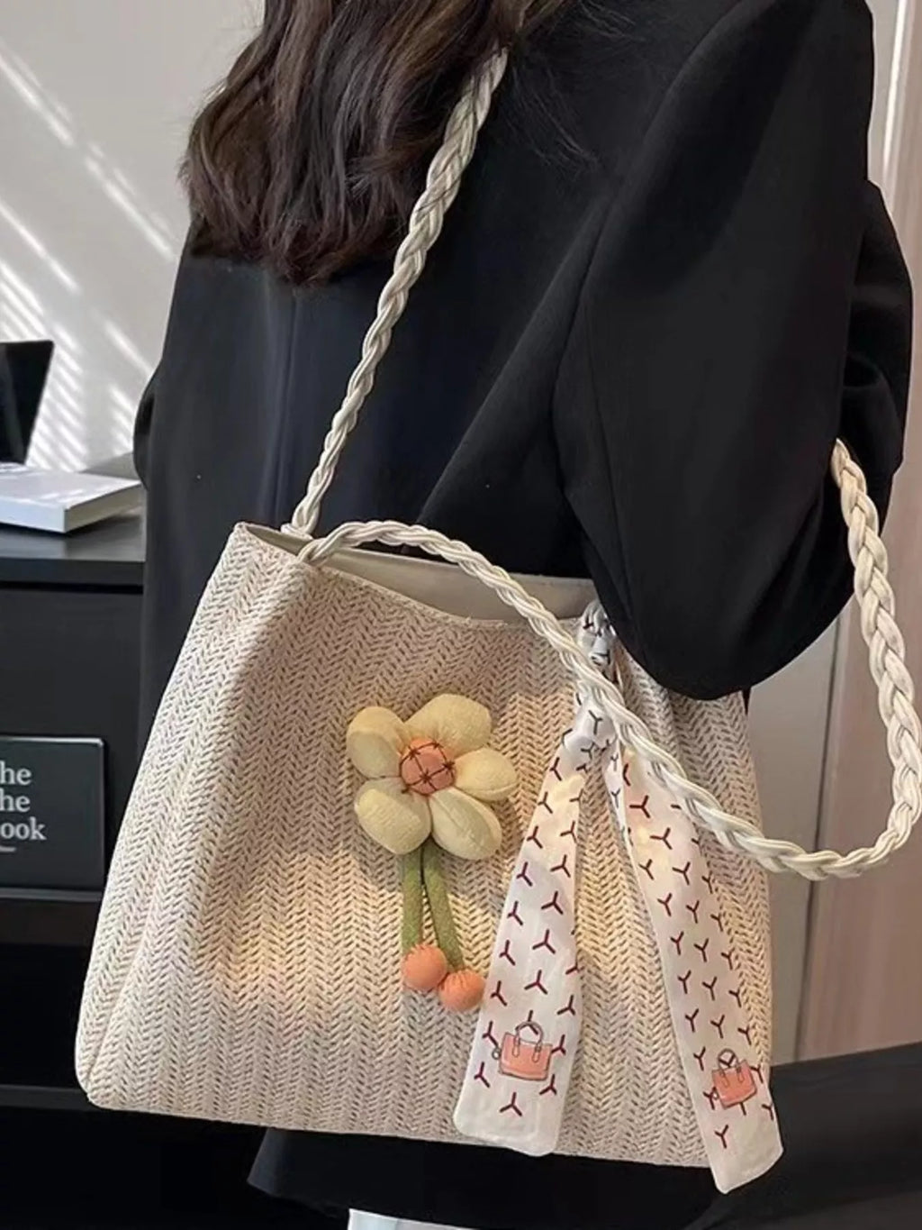 Woven straw tote bag with floral decor, stylish and spacious, ideal for summer outings and casual shopping.
