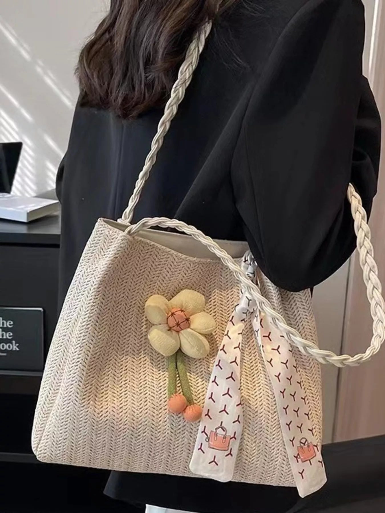 Woven straw tote bag with floral decor, stylish and spacious, ideal for summer outings and casual shopping.