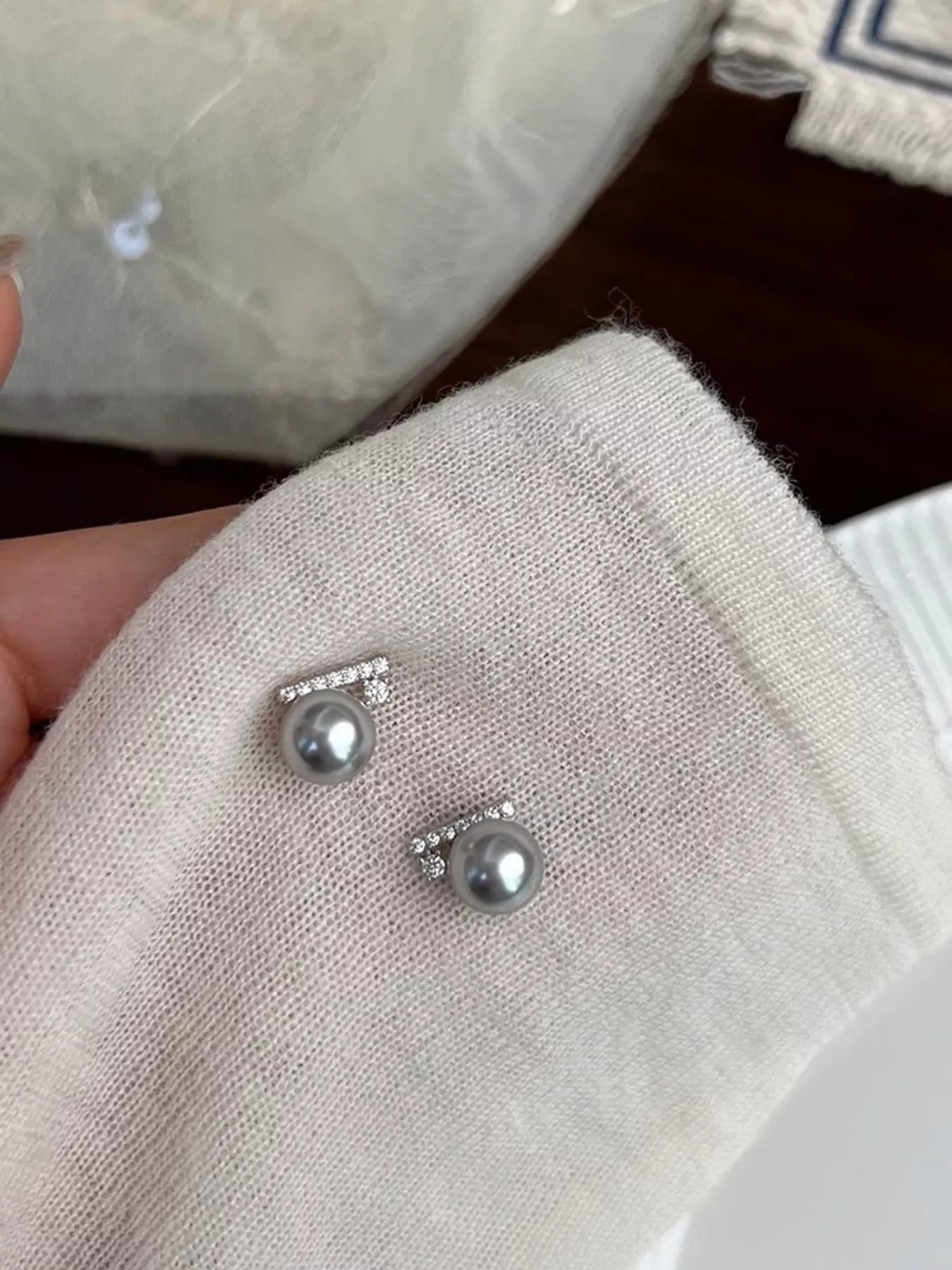 Close-up of zircon and pearl stud earrings from Plush Fashion Hub, showcasing sparkling stones and elegant pearl accents.