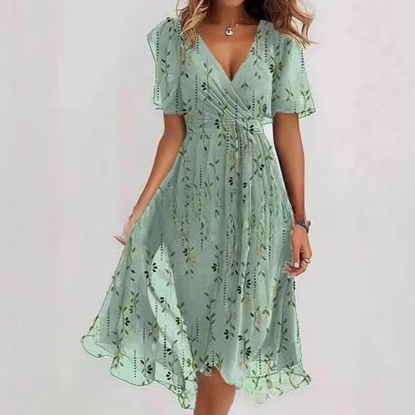 Floral print FitiqueFit A-line dress with V-neck, short sleeves, midi length, worn by a model in a bright outdoor setting.