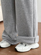 Simply Love casual drawstring high waist wide-leg sweatpants hanging on a rack, showcasing their relaxed fit and comfortable style.