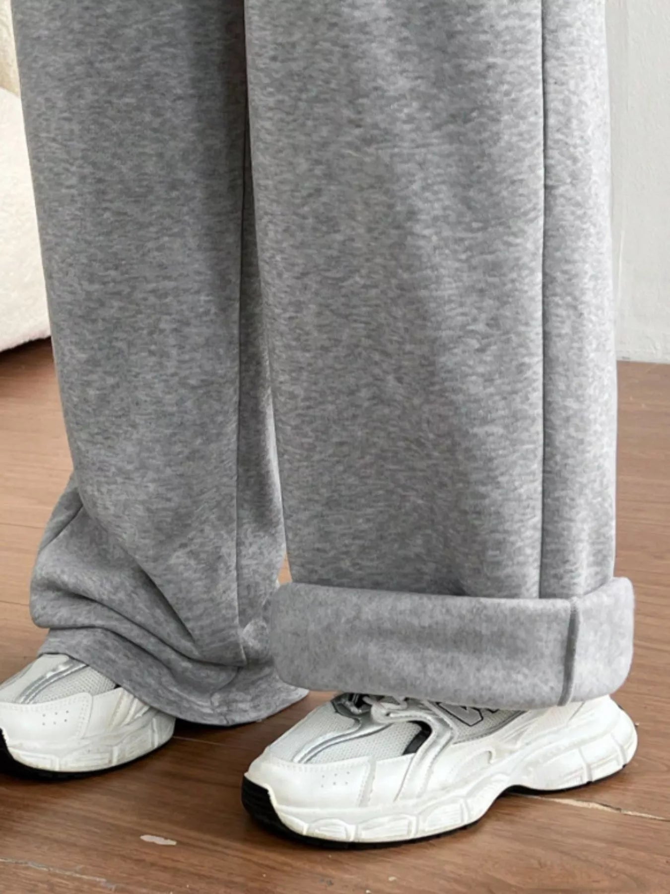 Simply Love casual drawstring high waist wide-leg sweatpants hanging on a rack, showcasing their relaxed fit and comfortable style.