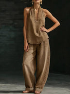 Plus size women's halter neck top and wide leg pants two-piece set by Trendsi, stylish dress with a halter top and flowy pants.