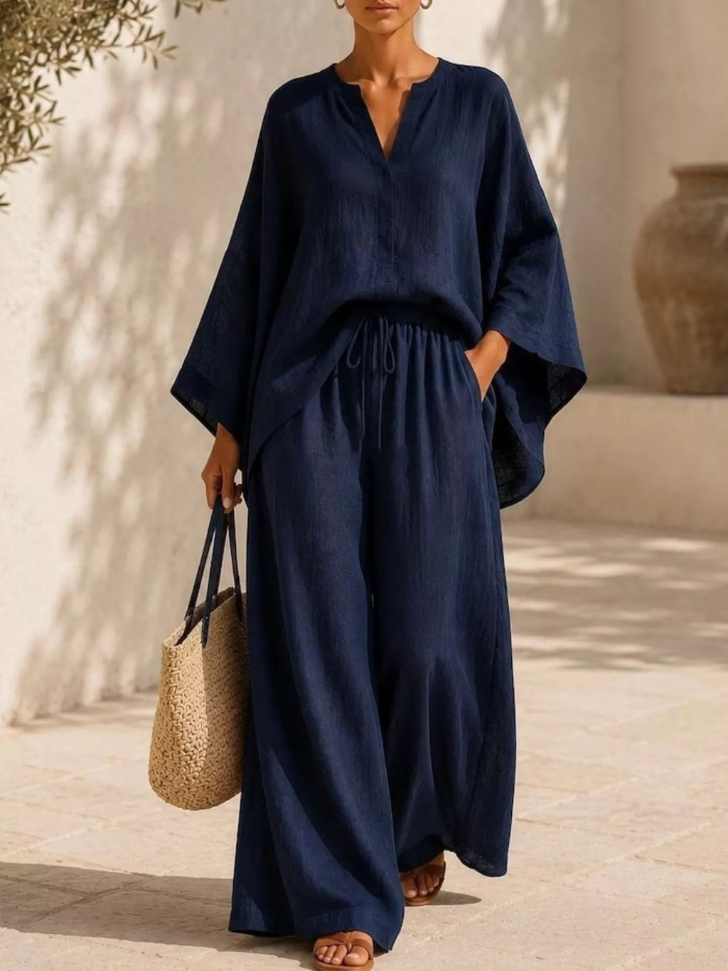 Plus size loungewear set featuring a notched long sleeve top and wide-leg pants, comfortable and stylish from Trendsi.