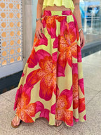 Women's floral print flowy maxi skirt with pockets, lightweight boho style from Trendsi, shown with a relaxed fit and vibrant floral pattern.