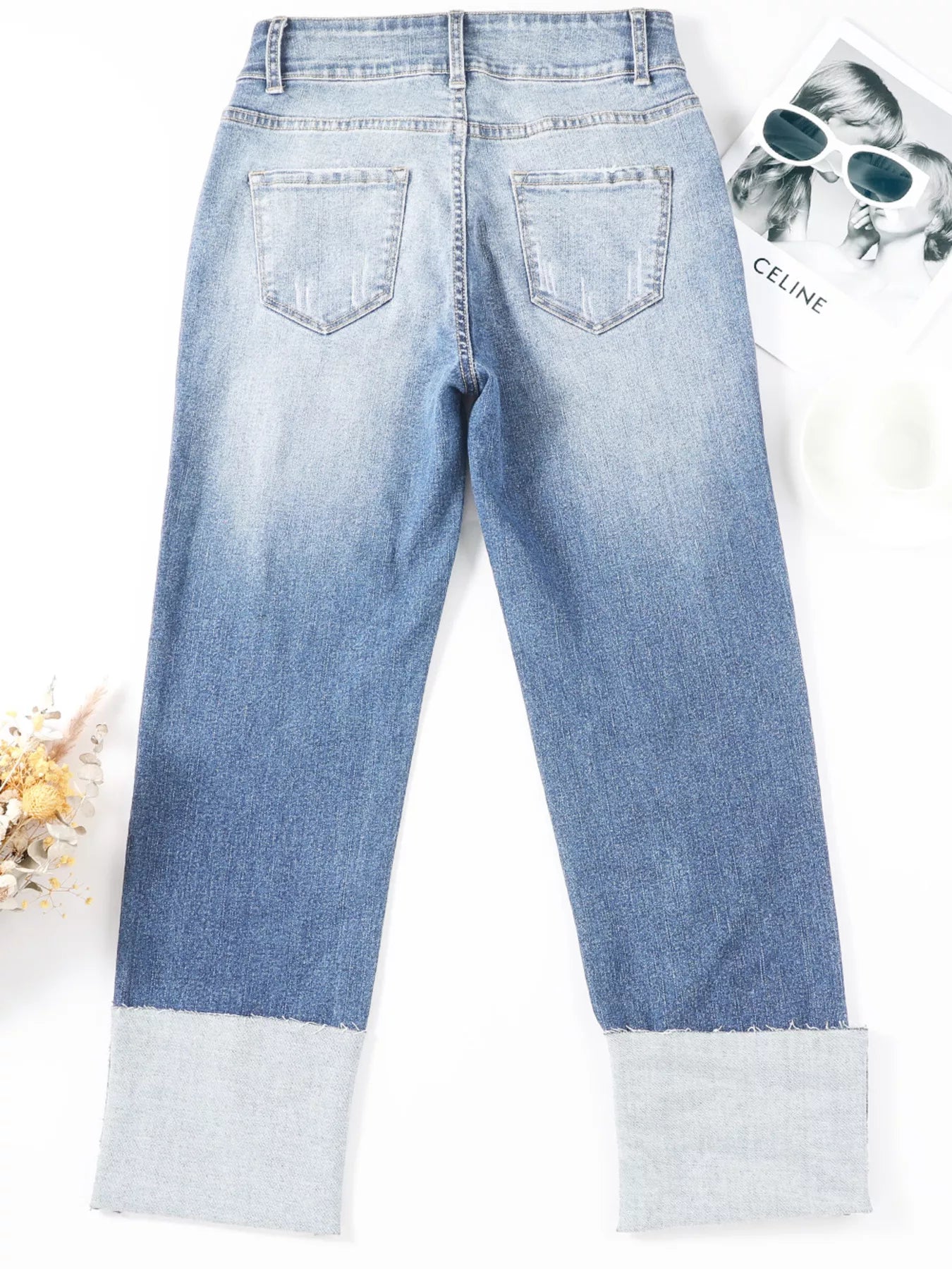 High waist distressed straight leg jeans by Trendsi, showcasing a casual fit with ripped details and classic denim style.