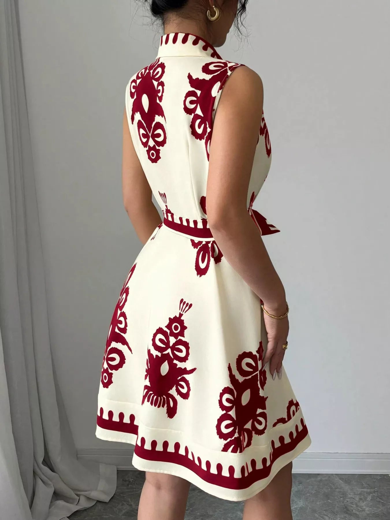 Sleeveless ruched printed tie waist dress by Plush Fashion Hub featuring a stylish design and flattering fit.