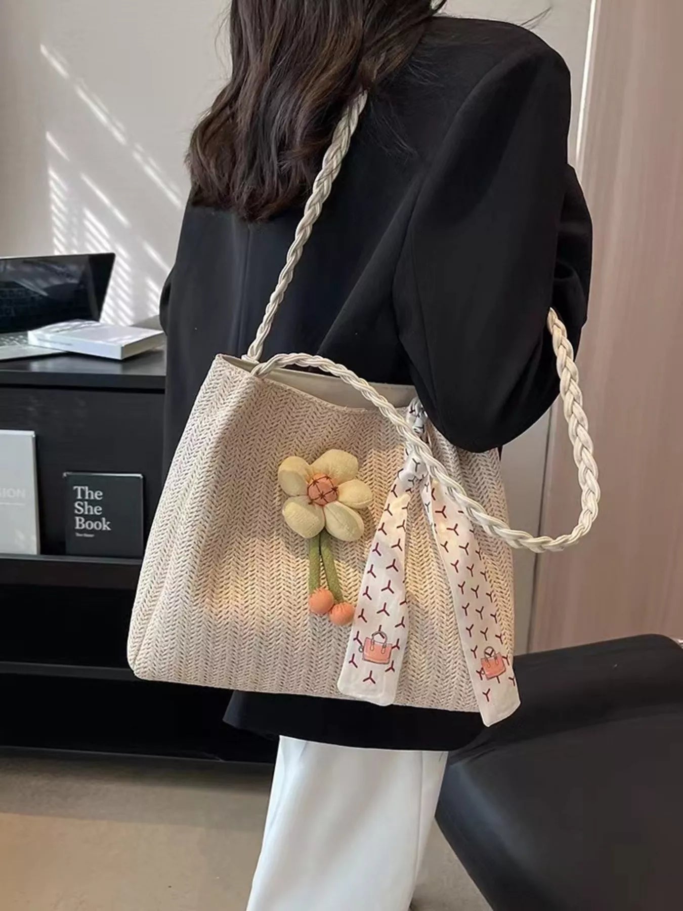 Woven straw tote bag with floral decor, natural color, and sturdy handles, ideal for casual outings and summer accessories.