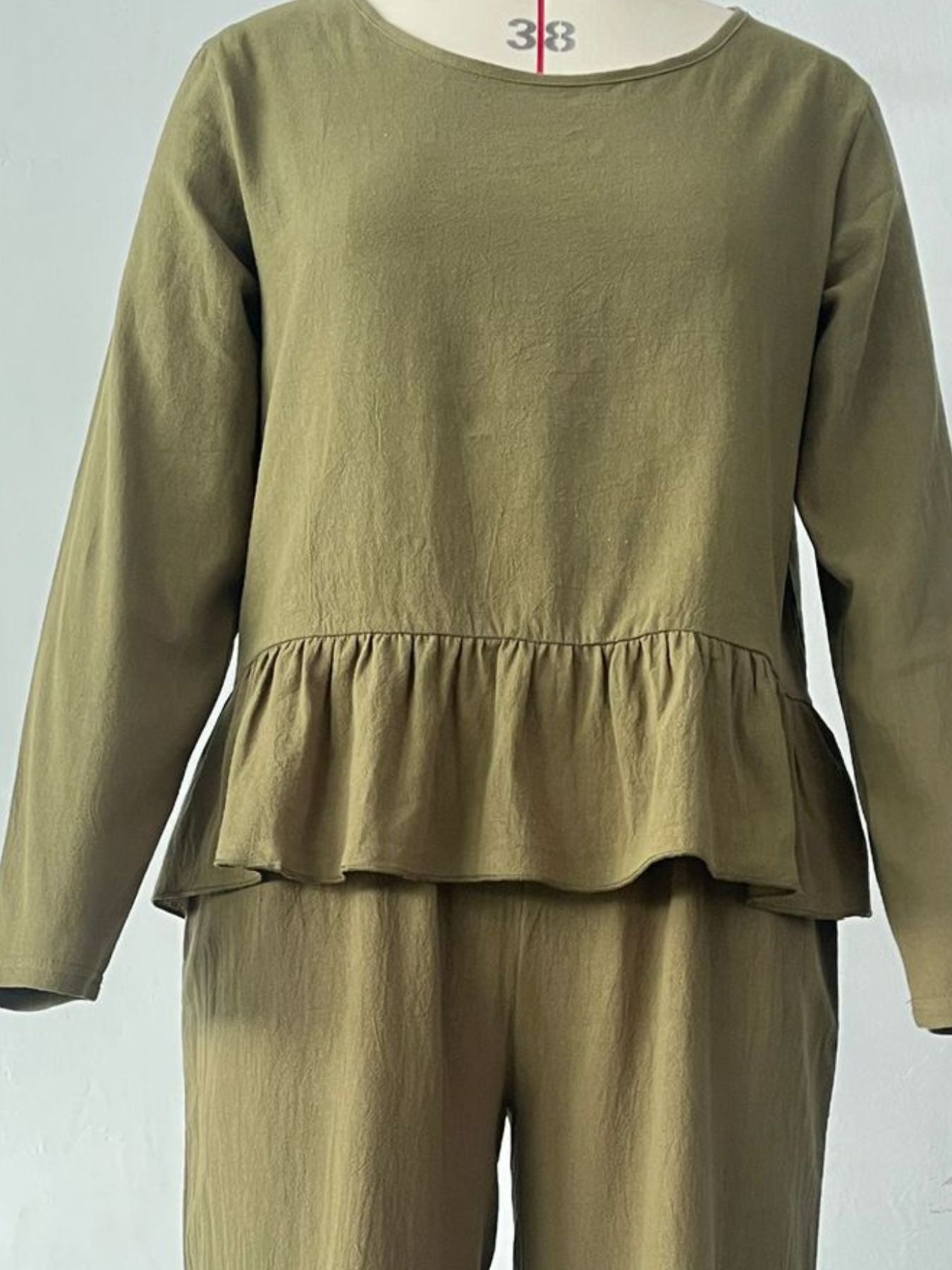 Women's ruffled hem long sleeve top and pants lounge set with pockets, stylish 2-piece set by Trendsi.