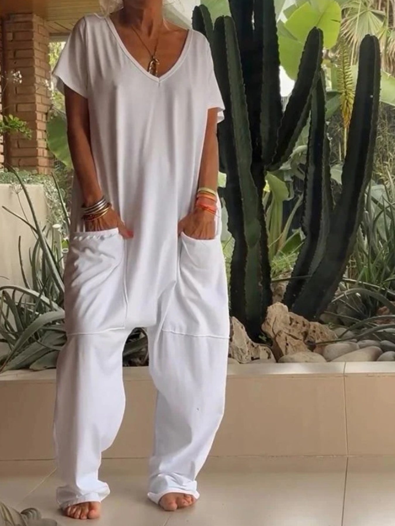 Plus size loose fit V-neck short sleeve jumpsuit with wide legs, trendy and comfortable from Trendsi.