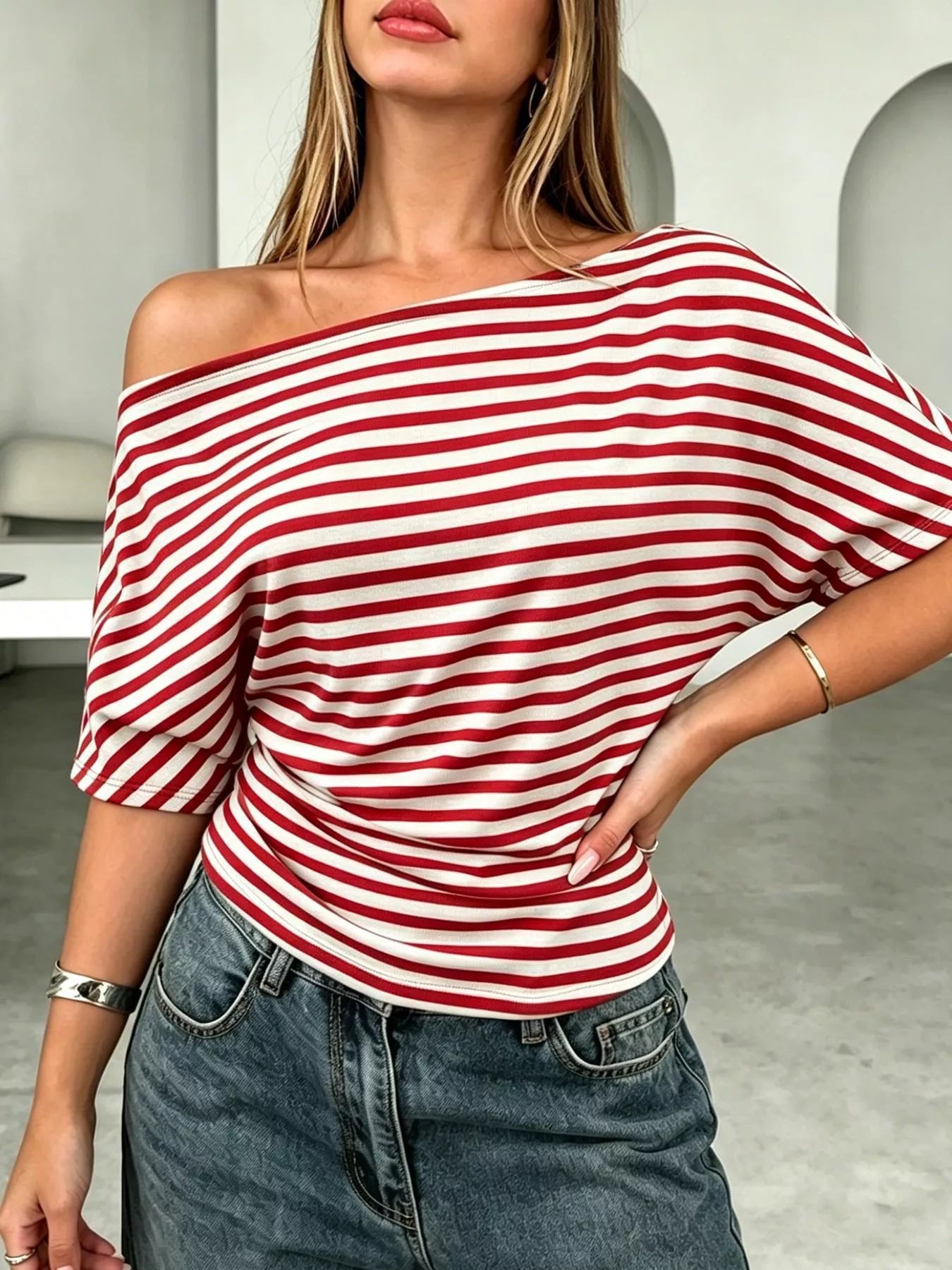 One shoulder striped dolman sleeve T-shirt from Trendsi, featuring a relaxed fit and bold horizontal stripes.