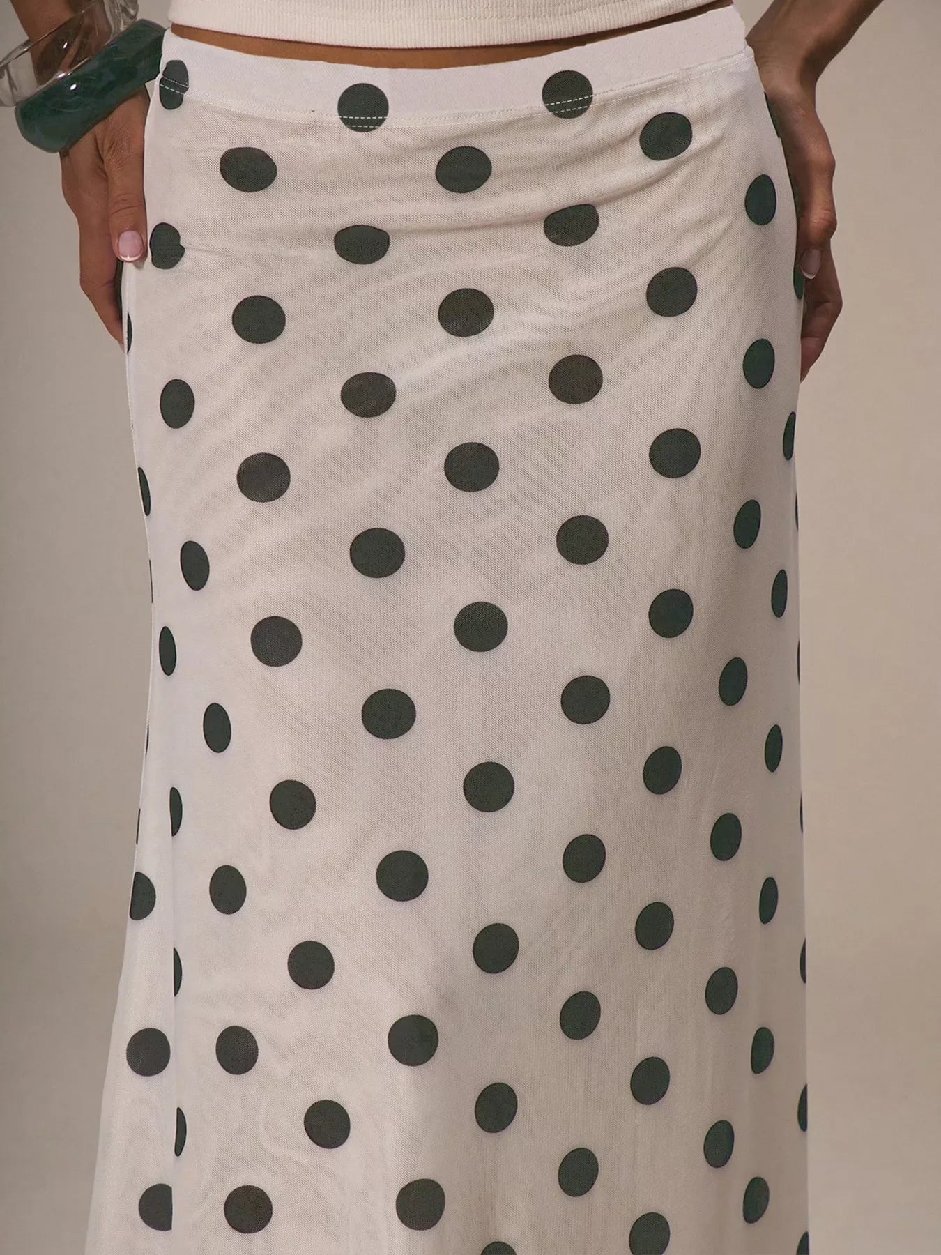 Women's vintage-inspired polka dot midi skirt by Trendsi, high-waisted A-line design, perfect for retro fashion looks.