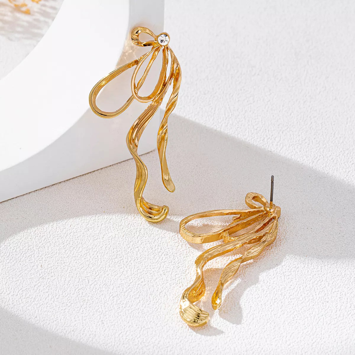 18K gold-plated bow earrings with delicate design and shiny finish, perfect for elegant accessories.