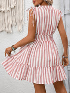 Women's striped smocked summer dress with ruffle hem by Trendsi, featuring a fitted bodice and flowing skirt.