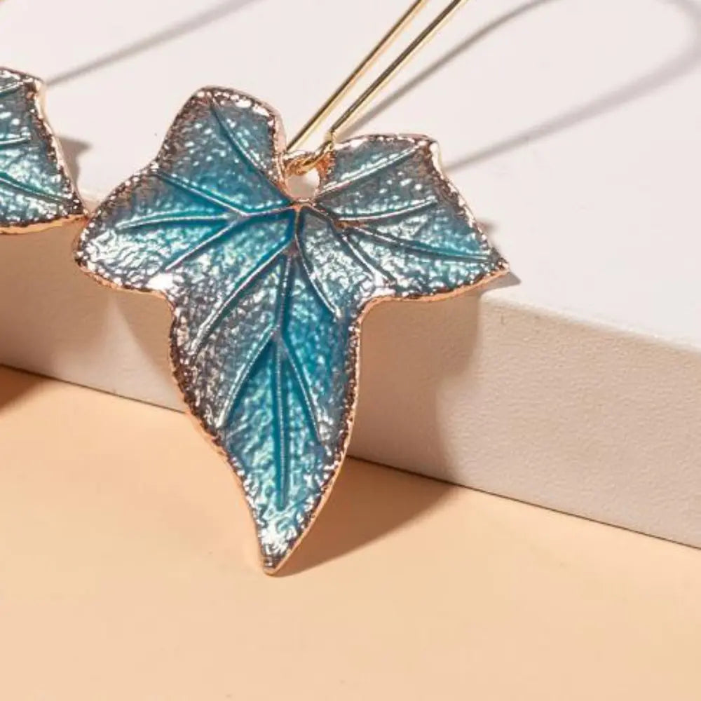 Gold alloy leaf drop earrings with intricate leaf design, stylish jewelry accessory for elegant occasions.
