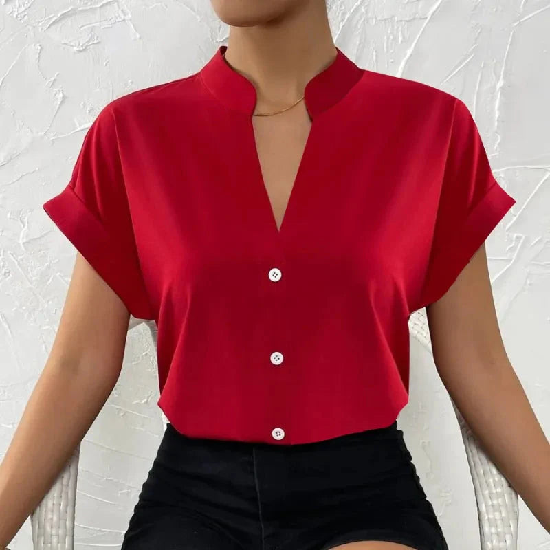 Light orange satin V-neck short sleeve shirt for women, casualwear from Plush Fashion Hub, displayed on a hanger.