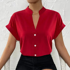 Light orange satin V-neck short sleeve shirt for women, casualwear from Plush Fashion Hub, displayed on a hanger.