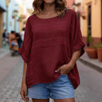 Loose-fitting LadyShow.Store top with crew neck and three-quarter sleeves, shown on a model in a casual indoor setting.