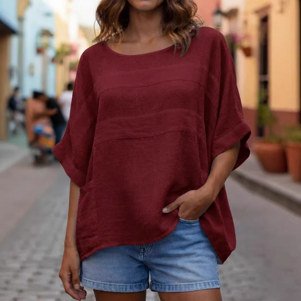 Loose-fitting LadyShow.Store top with crew neck and three-quarter sleeves, shown on a model in a casual indoor setting.