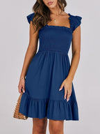 Women's smocked ruffle hem mini dress by Trendsi, lightweight casual summer dress with a relaxed fit and ruffled details.