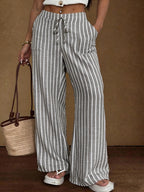 Women's striped wide-leg trousers with lace-up elastic waistband and loose fit, stylishly displayed in the image.
