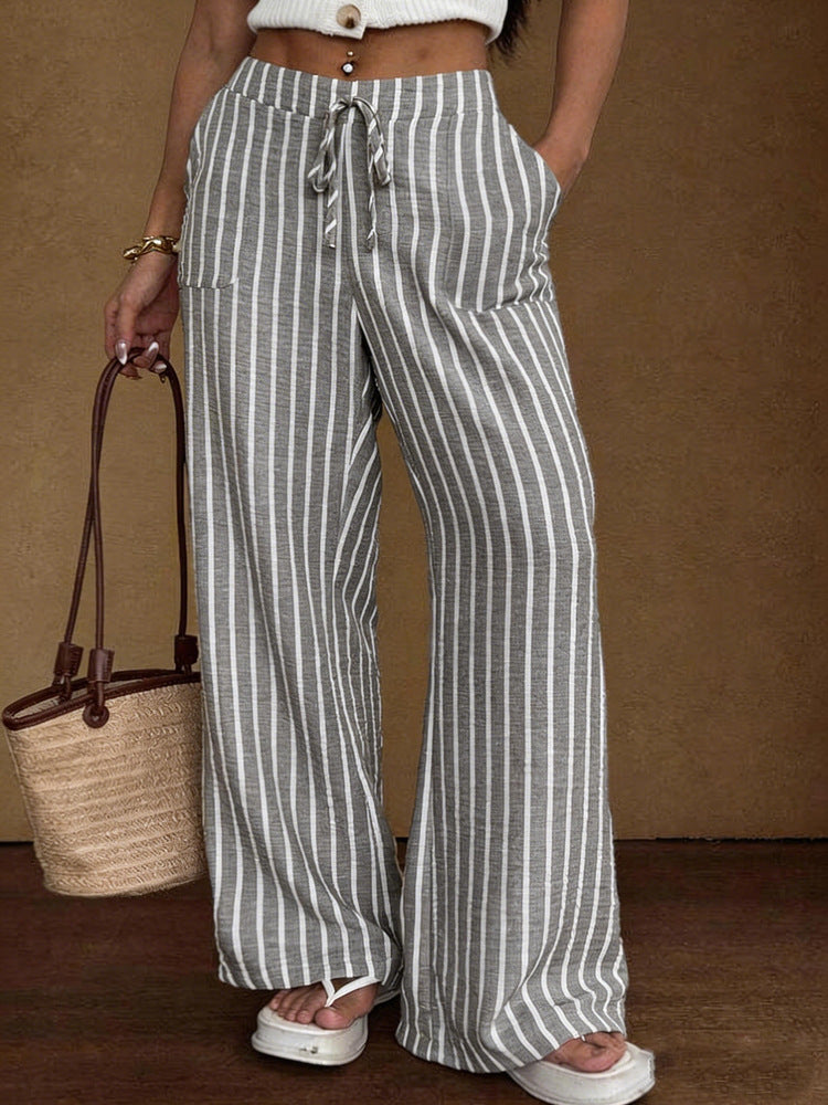 Women's striped wide-leg trousers with lace-up elastic waistband and loose fit, stylishly displayed in the image.