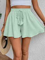 Flowy drawstring waist romper shorts from Trendsi, with lightweight fabric and relaxed fit, perfect for casual summer wear.