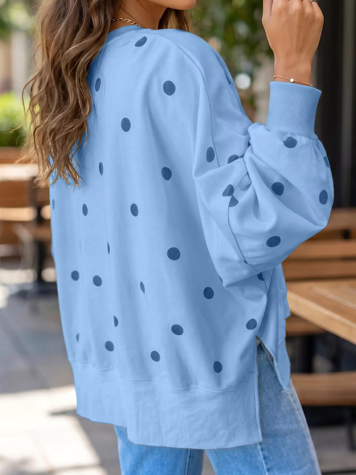 Polka dot oversized sweatshirt with side slit from Trendsi, featuring a relaxed fit and casual style in the image.