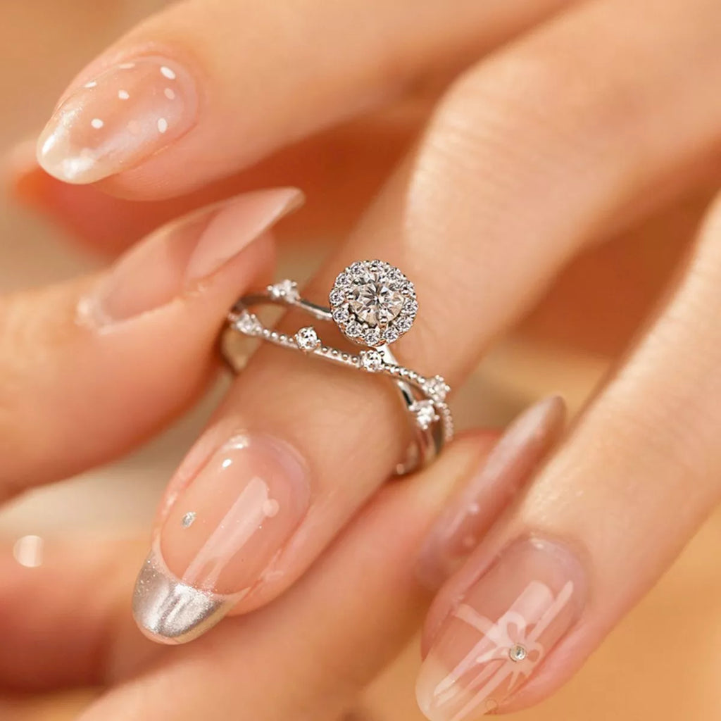 Sterling silver layered ring with 1 carat moissanite gemstone, featuring a stylish design and sparkling center stone.
