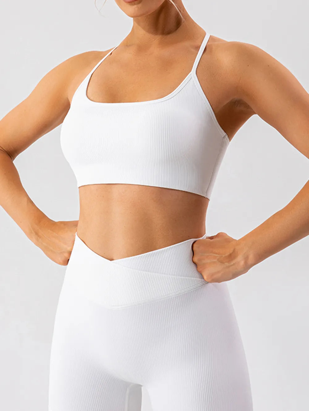 Trendsi spaghetti strap active bra in black, lightweight athletic wear with thin straps and supportive design for exercise or casual wear.
