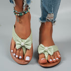 Shopimist toe post bow sandals featuring a comfortable flat sole and stylish bow detail on the straps.