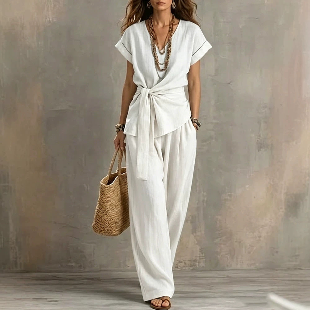 Women’s V-neck short-sleeve top and matching pants two-piece set by Plush Fashion Hub, displayed on a hanger.