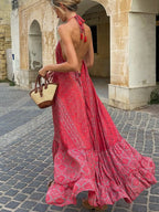 Tiered halter neck maxi dress by Trendsi featuring flowing fabric and a tiered design, perfect for elegant summer occasions.