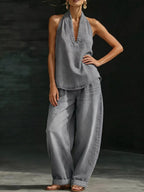 Plus size women's halter neck top and wide-leg pants two-piece set, stylish dress from Trendsi, featuring a halter top and flowy pants.