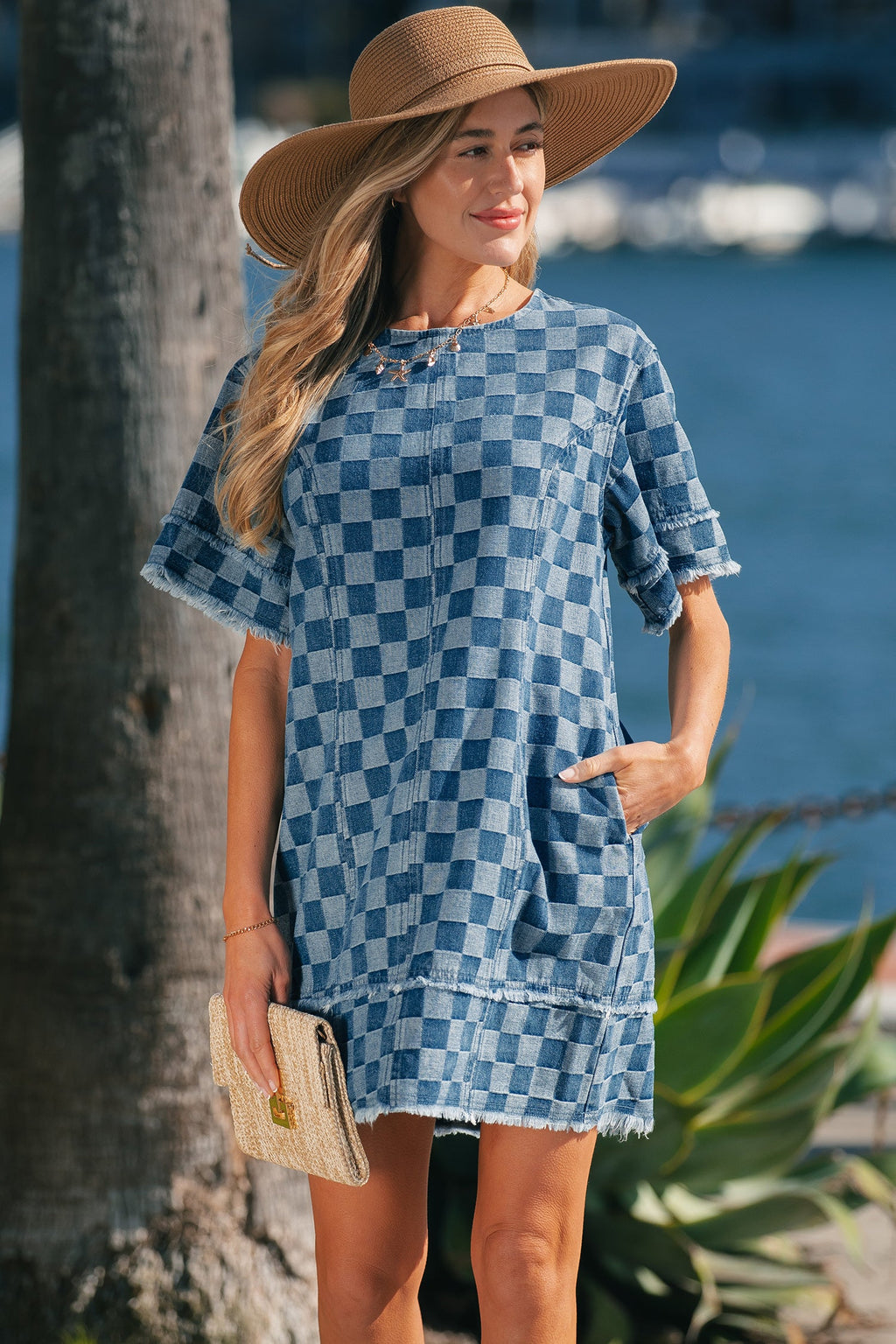 Threaded Pear Jessie Hem checkered mini dress displayed on a hanger, showcasing its stylish pattern and fit.