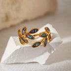 18K gold-plated resin leaf bypass ring with detailed leaf design, showcasing elegant jewelry craftsmanship.