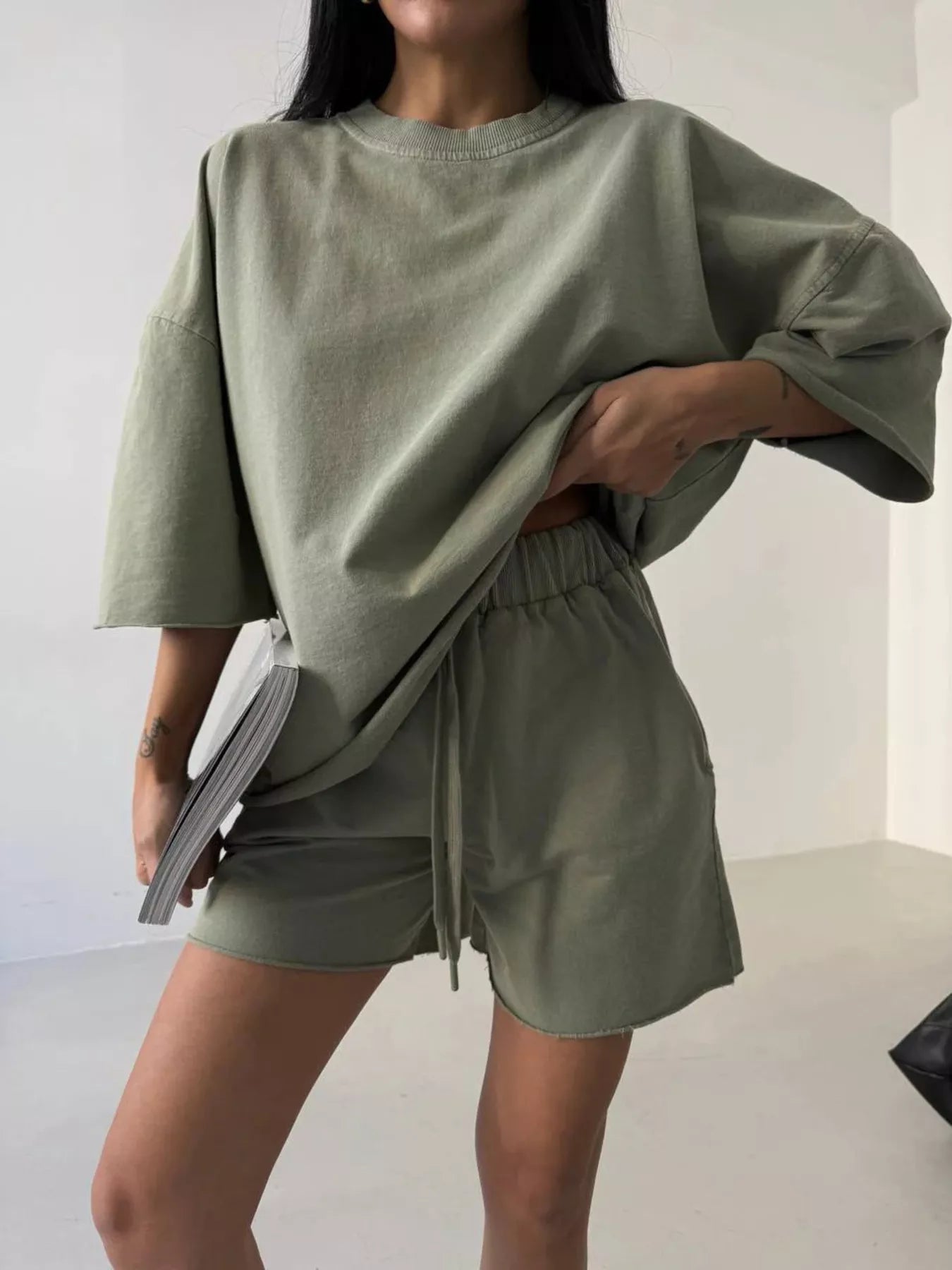 Vintage wash oversized lounge set featuring a relaxed T-shirt and matching shorts in soft, faded fabric by Trendsi.