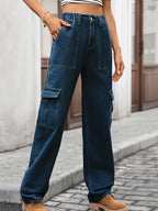 High-waisted cargo denim jeans from Plush Fashion Shop featuring multiple front and side pockets and a relaxed fit.