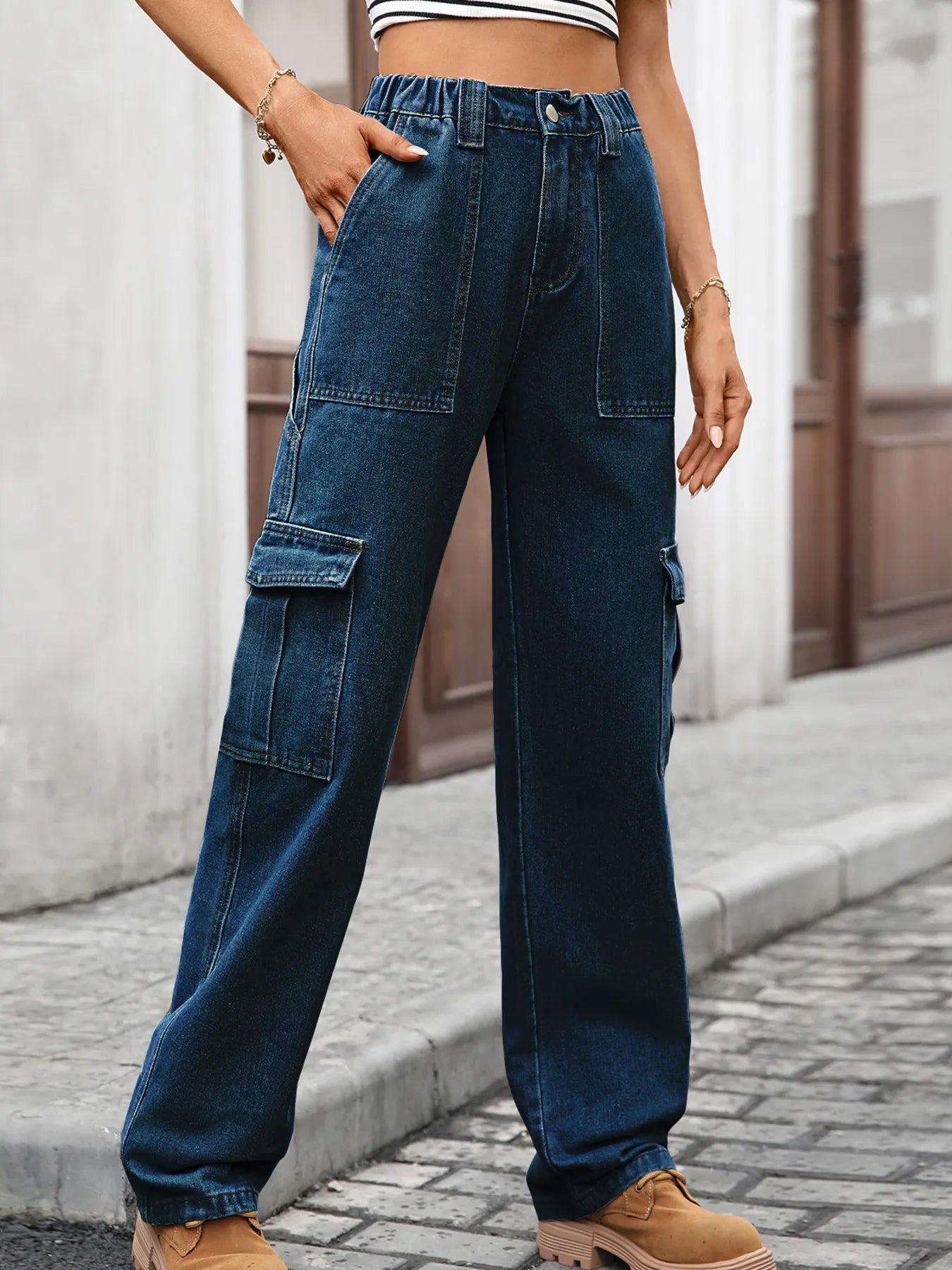 High-waisted cargo denim jeans from Plush Fashion Shop featuring multiple front and side pockets and a relaxed fit.