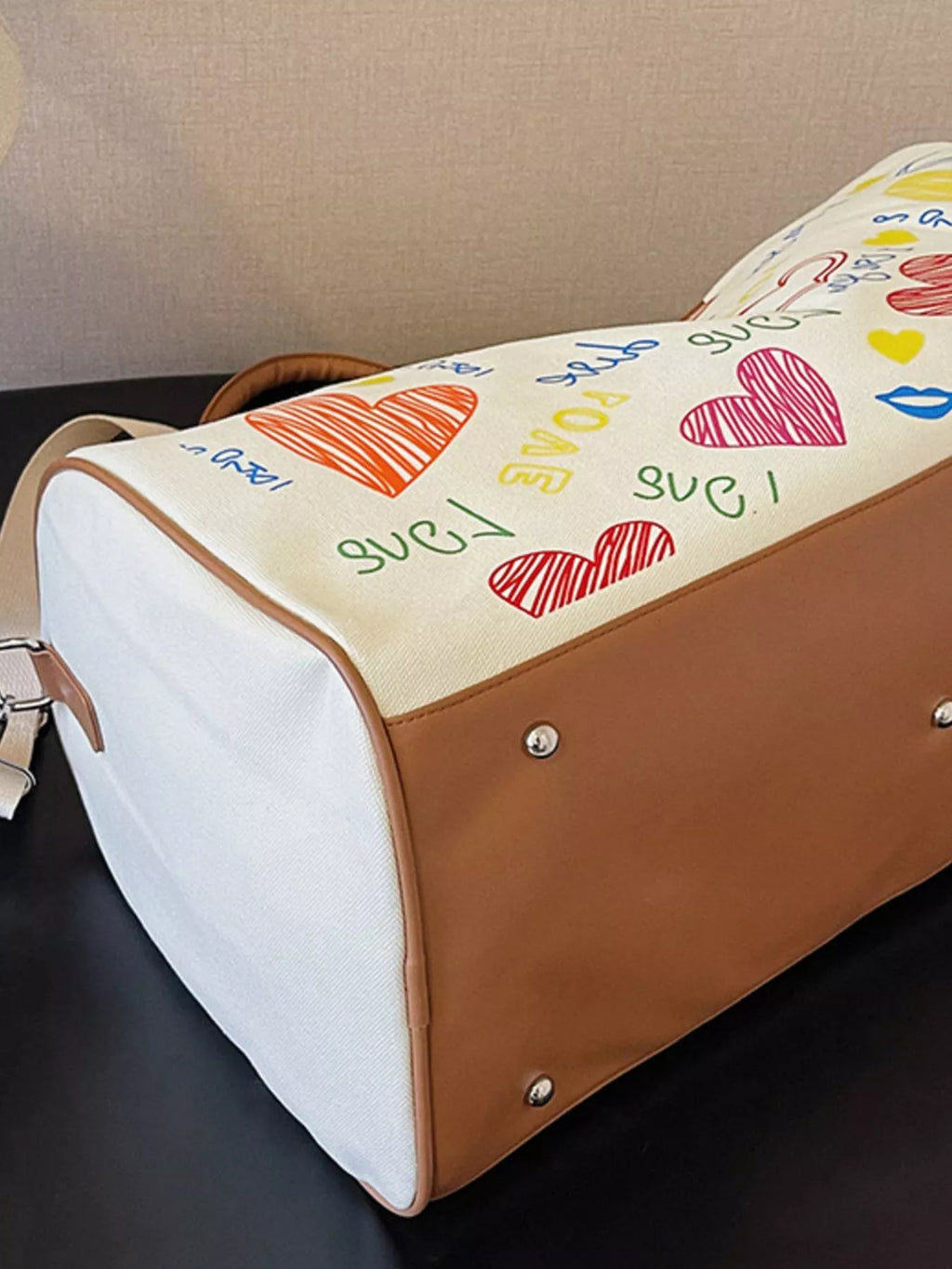 Printed duffel bag with adjustable strap from Shopimist, showing a stylish bag with a colorful print and sturdy handle.