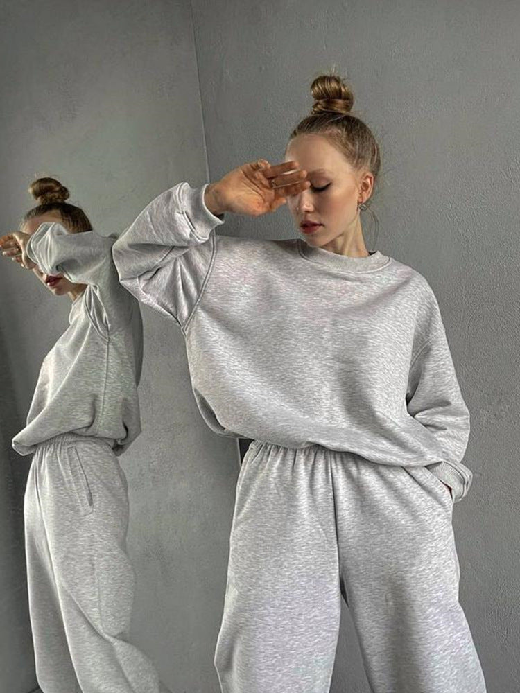 Women's loose fit crewneck sweatshirt and jogger pants two-piece set by Plush Fashion Hub, shown in a casual, comfortable style.