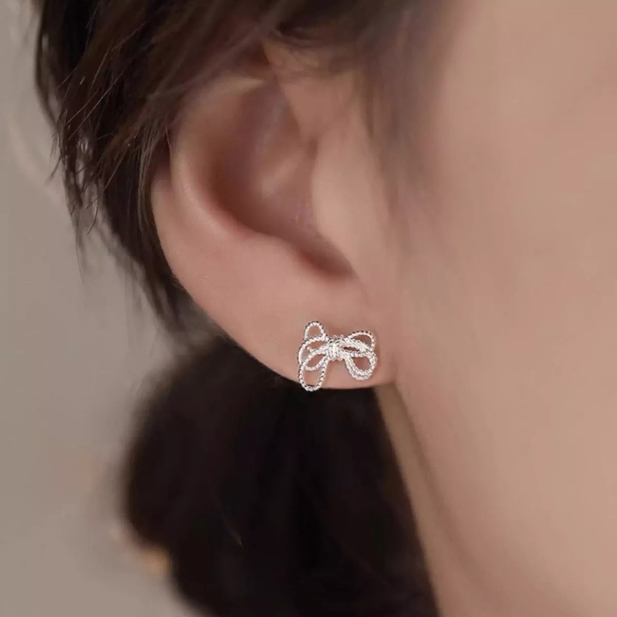 925 sterling silver bow knot stud earrings with a polished finish, featuring delicate, elegant design for everyday wear