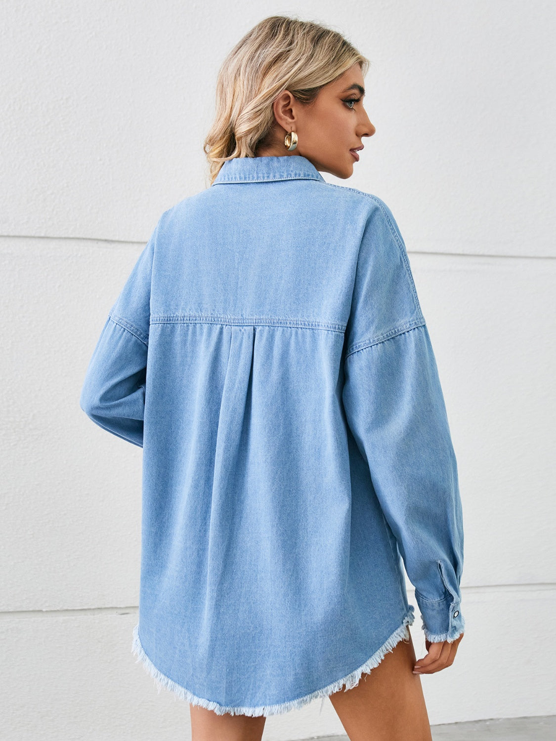 Distressed raw hem dropped shoulder denim jacket by Plush Fashion Hub, featuring a casual fit and stylish worn-in look.