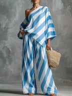 Plus size striped one-shoulder top and wide-leg pants set by Plush Fashion Hub, stylish and comfortable casual outfit.