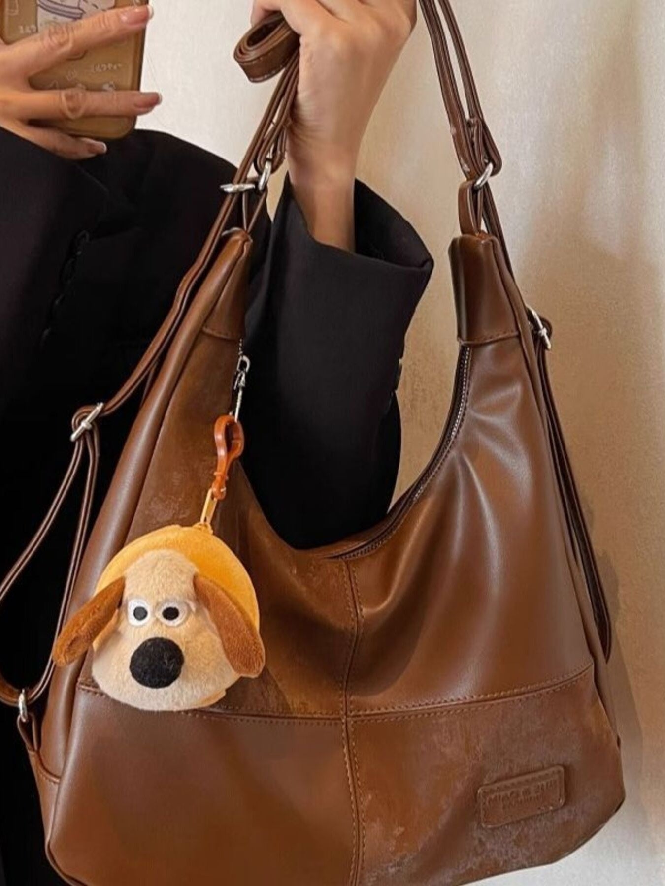Vintage-inspired PU leather slouchy hobo shoulder bag with a relaxed style and spacious interior, ideal for casual everyday use.