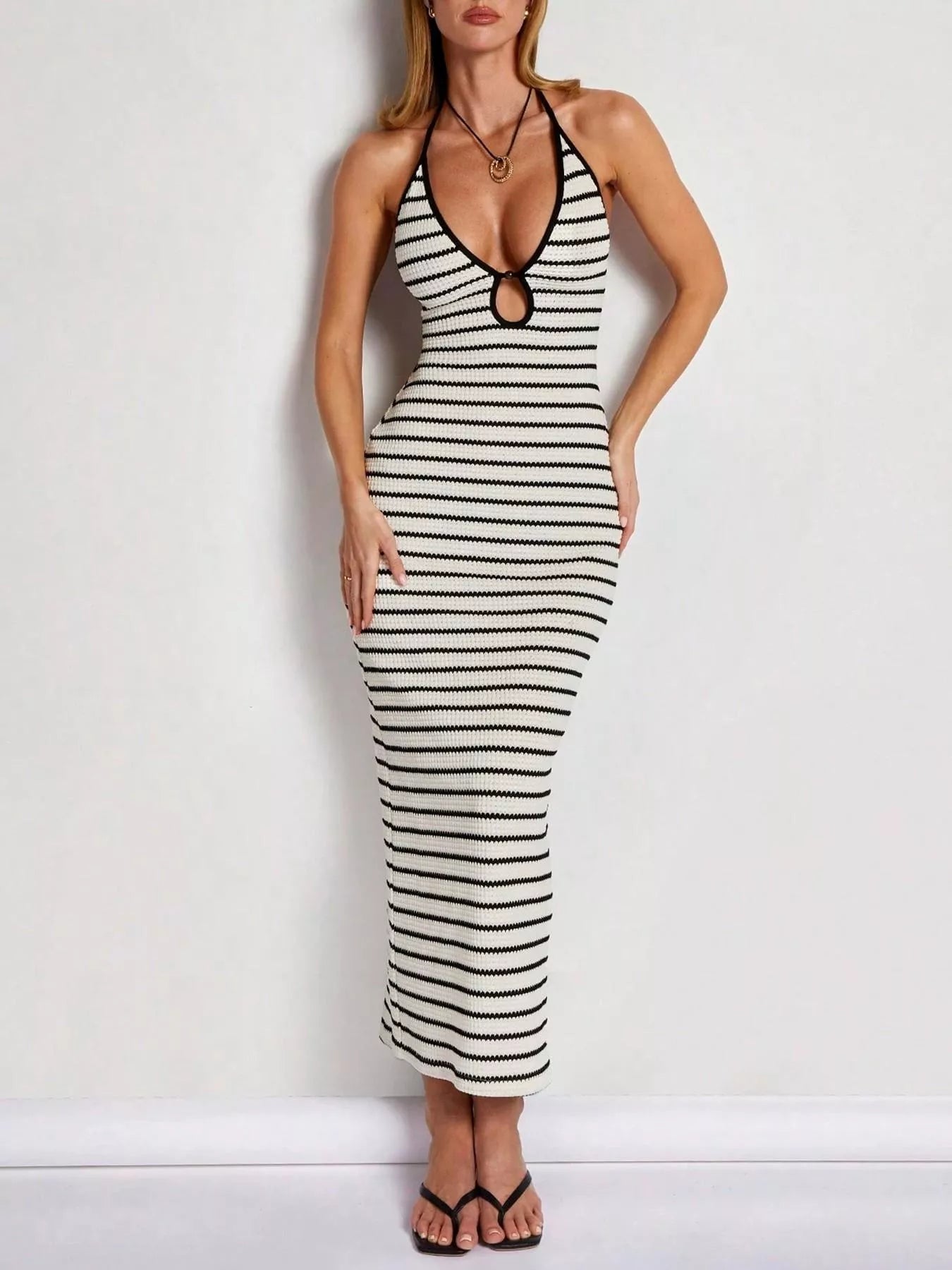 Plush Fashion Hub striped halter neck maxi dress with bold horizontal stripes and flowing fabric, perfect for summer wear.